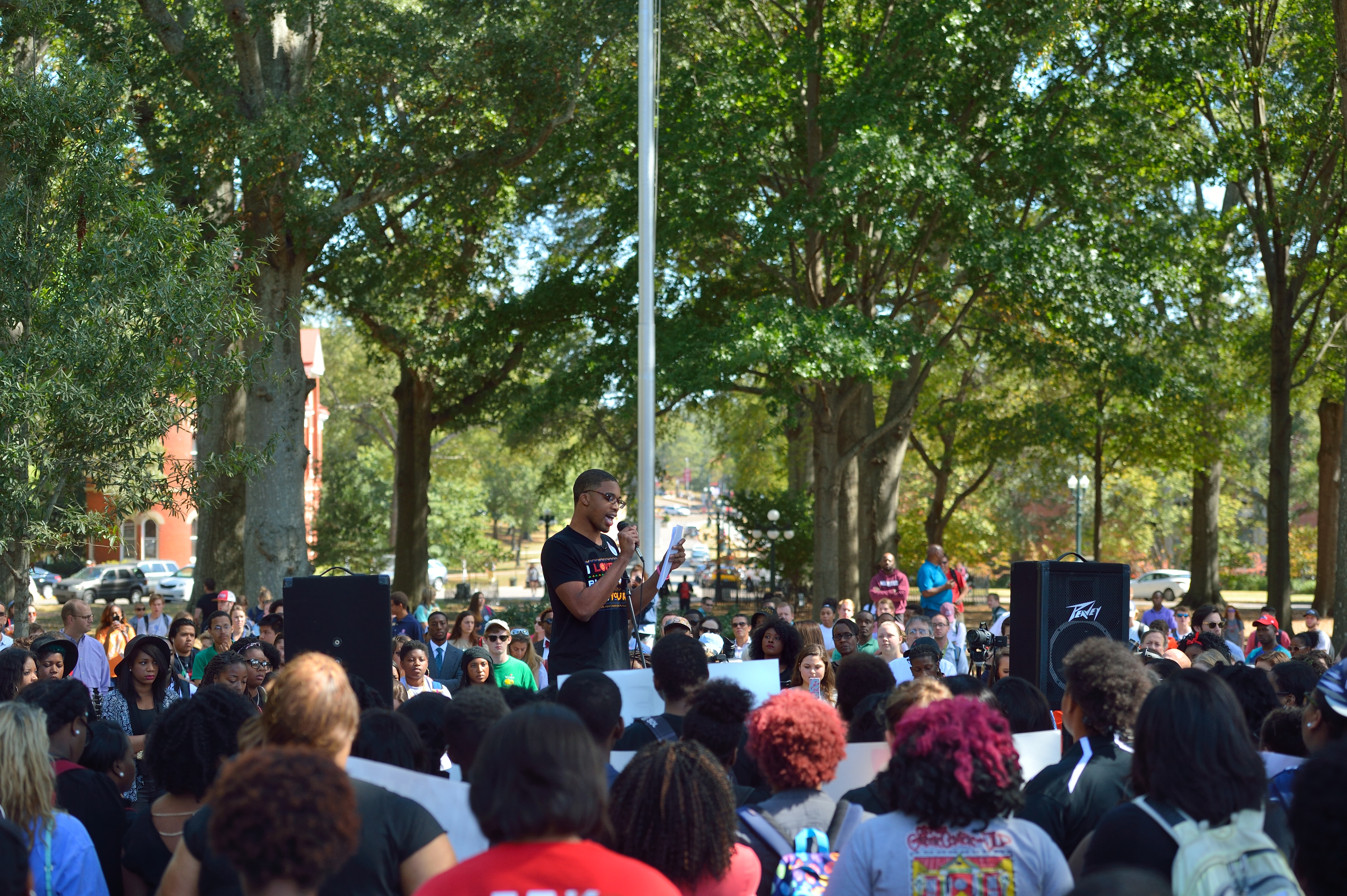 Buka Okoye, president of the campus NAACP, reads from a prepared statement at the rally in the circle asking that the ASB request the administration cease displaying the Mississippi state flag because of the confederate symbol it contains. Photo by Kevin Bain/Ole Miss Communications