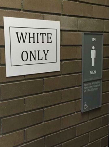 A student’s “black only” and “white only” posters, which were intended to draw attention to racism, were removed by campus police and investigated.