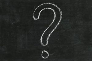 large question mark in chalk on a blackboard
