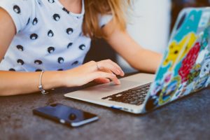 Student using a laptop and mobile phone