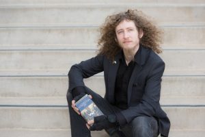 Kevin Shaw holding a pocket edition of the US constitution